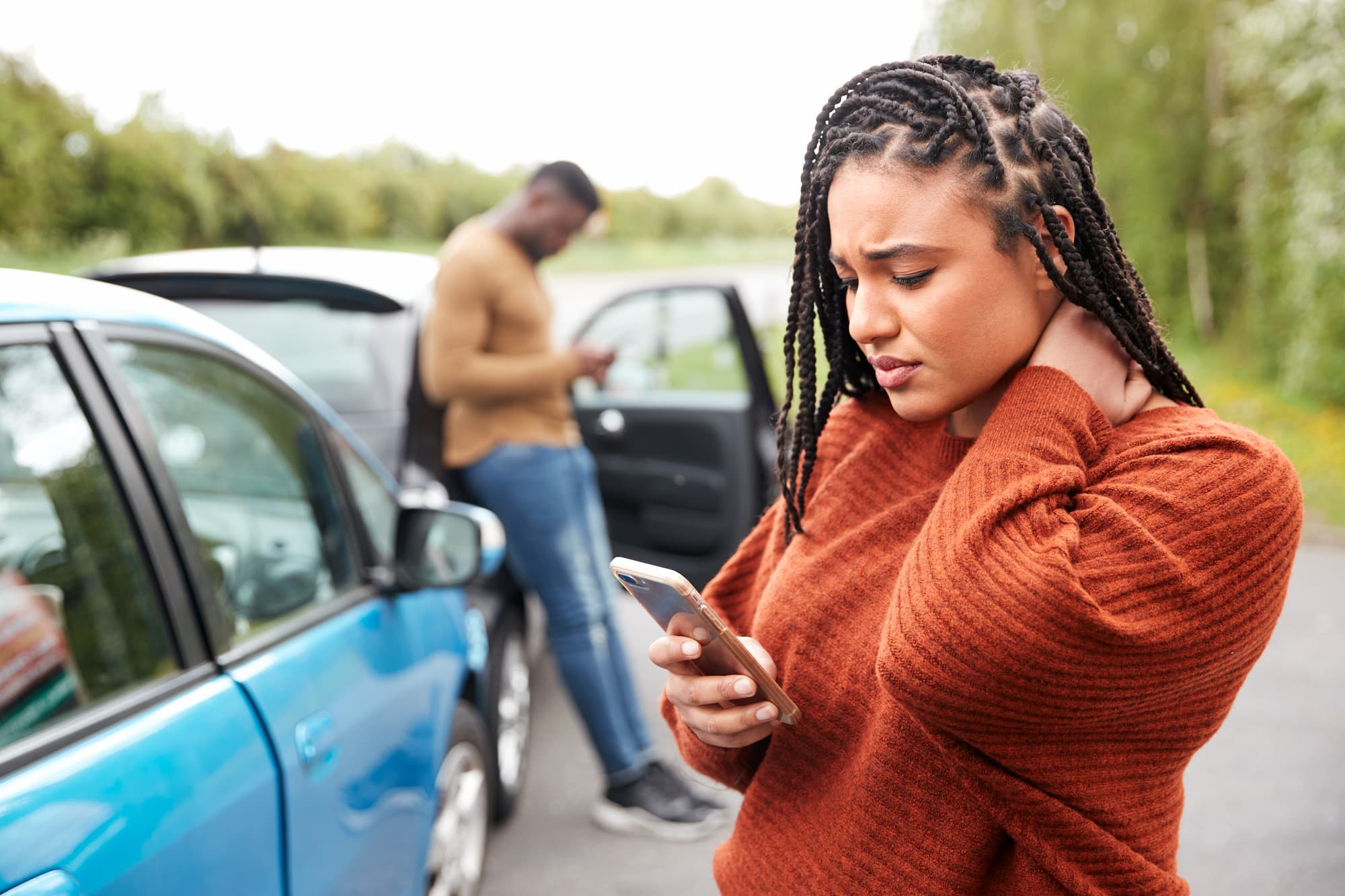woman on phone after being hit by uninsured driver