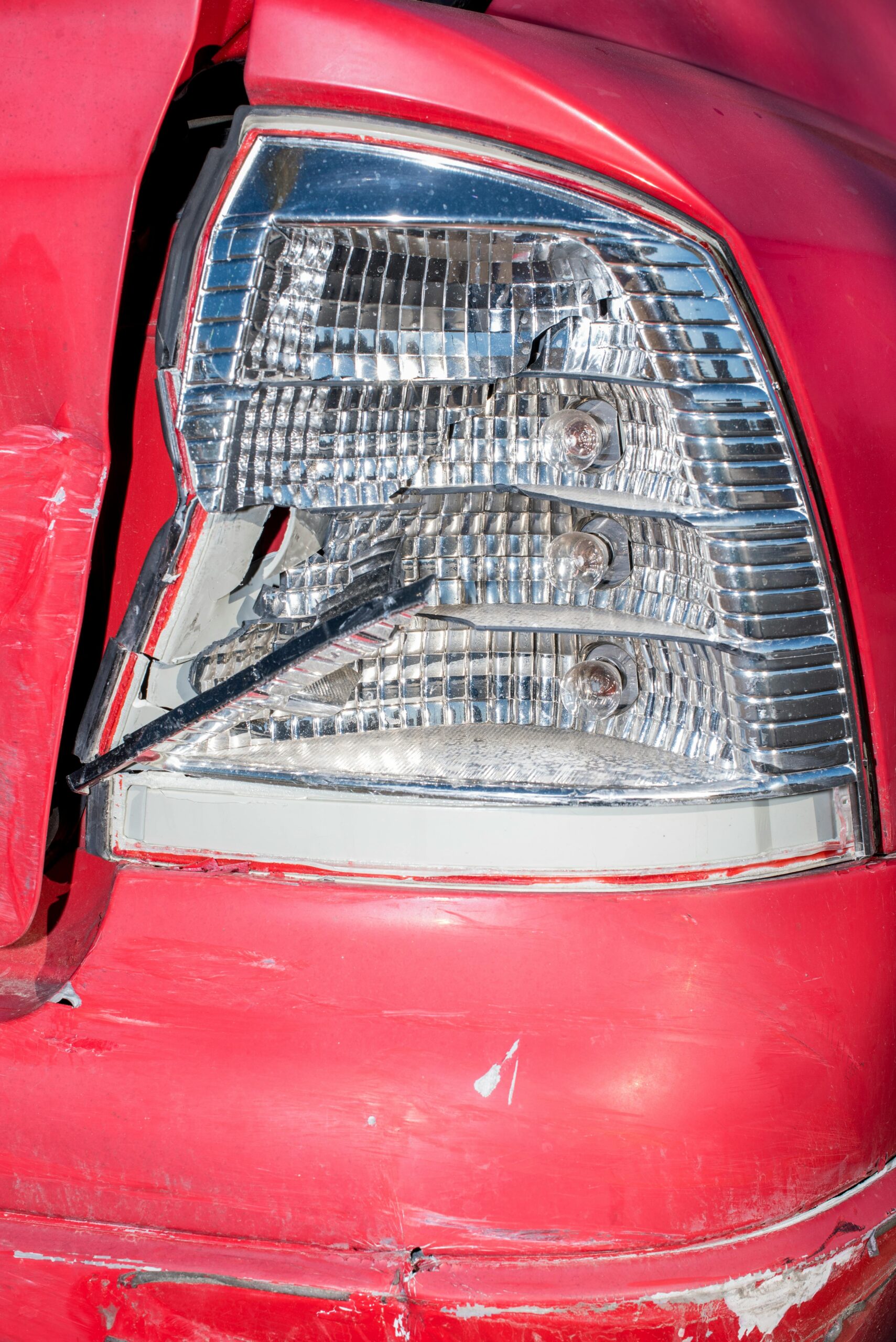 Close-up of a damaged red car from a rear-end collision, illustrating the rear-end collision claim process explained.